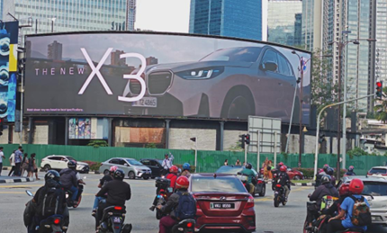 High-impact LED billboard displaying BMW X3 at a major Kuala Lumpur intersection — Prism Media Hub Malaysia premium highway advertising